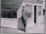 Photograph of Lou LaPorta standing in front of the Lou LaPorta Insurance Agency building, Henderson, Nevada, 1952