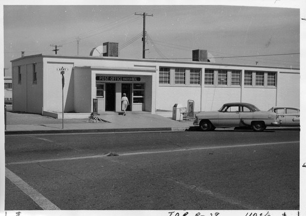 Photograph of a woman walking into the Post Office in Henderson