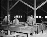 Photograph of men working on bus bars at Basic Magnesium, Inc.