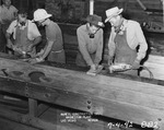 Photograph of men sanding silver bus bars at Basic Magnesium, Inc.