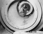 Photograph of a man in a brick-lined rotary kiln at Basic Magnesium, Inc.
