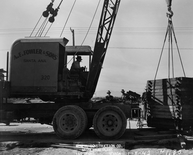 Photograph of a crane operator and men at Basic Magnesium, Inc.