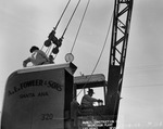 Photograph of a crane operator and men at Basic Magnesium, Inc.