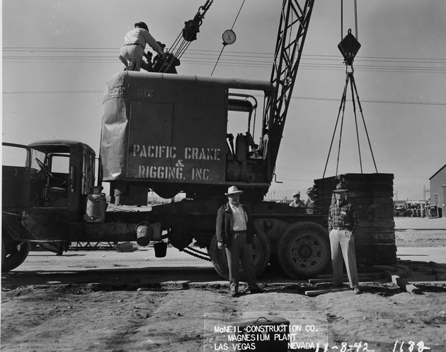 Photograph of a crane and men at Basic Magnesium, Inc.