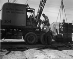 Photograph of a crane and men at Basic Magnesium, Inc.