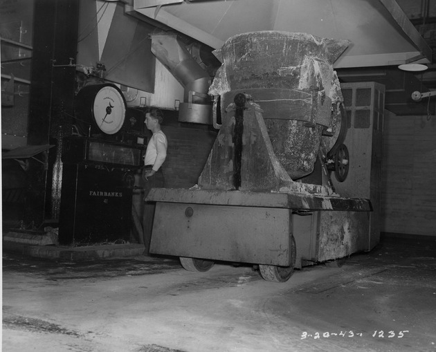 Photograph of a man weighing a ladle truck