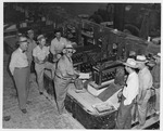 Photograph of a group of men and electrolytic cells at Basic Magnesium, Inc.
