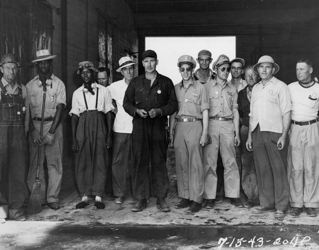 Photograph of Memphis Belle crewmen stand with Basic Magnesium, Inc. plant workers