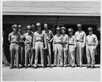Photograph of a Memphis Belle crewmen standing in front of a building