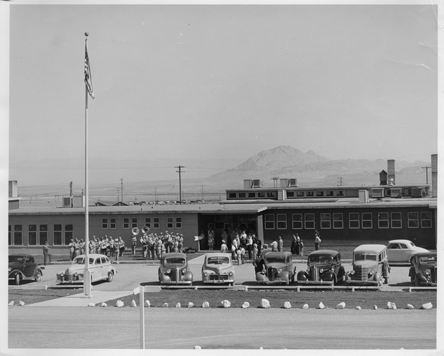 Photographs of a band playing outside of the Basic Magnesium, Inc. administration building