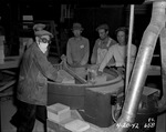 Photograph of men and brick sander at Basic Magnesium, Inc.