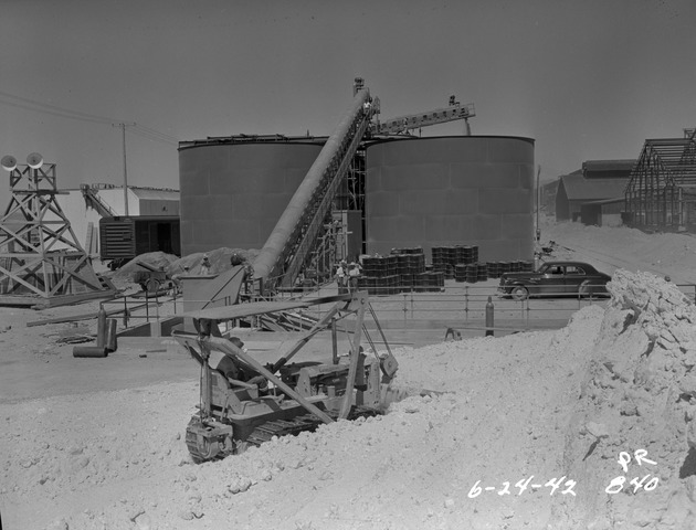 Photograph of a salt elevating conveyor and brine tanks at Basic Magnesium, Inc.