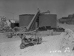 Photograph of a salt elevating conveyor and brine tanks at Basic Magnesium, Inc.