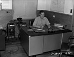 Photograph of a man at desk at Basic Magnesium, Inc.