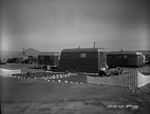 Photograph of a mother and son outside their home at Basic Magnesium, Inc.'s Trailer Camp