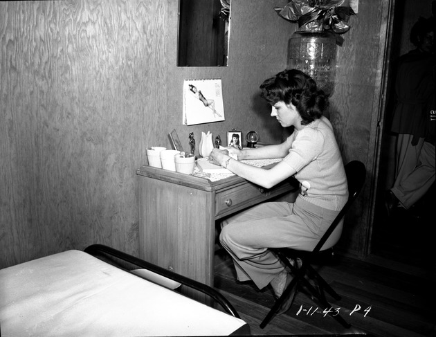 Photograph of Charlene Creger in her dormitory room at Basic Magnesium, Inc.