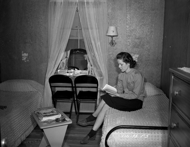 Photograph of a woman in her dormitory room at Basic Magnesium, Inc.