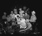 Photograph of men and silver bus bars at Basic Magnesium, Inc.