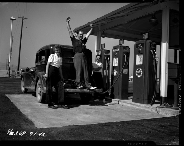 Photograph of Chuck Ethridge, Gertrude Olsen, and  Maude Hughes at a gas station