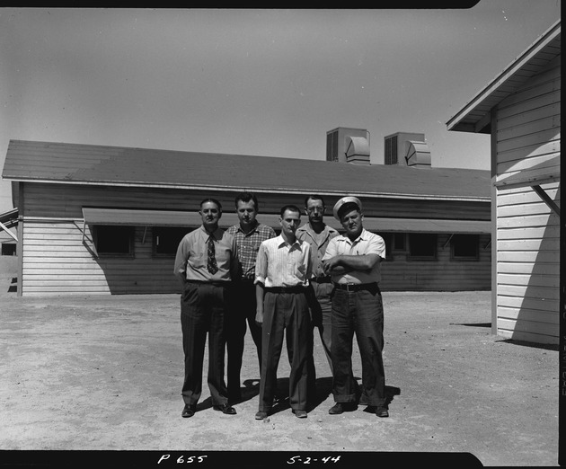 Photograph of the softball team managers at Basic Magnesium, Inc.