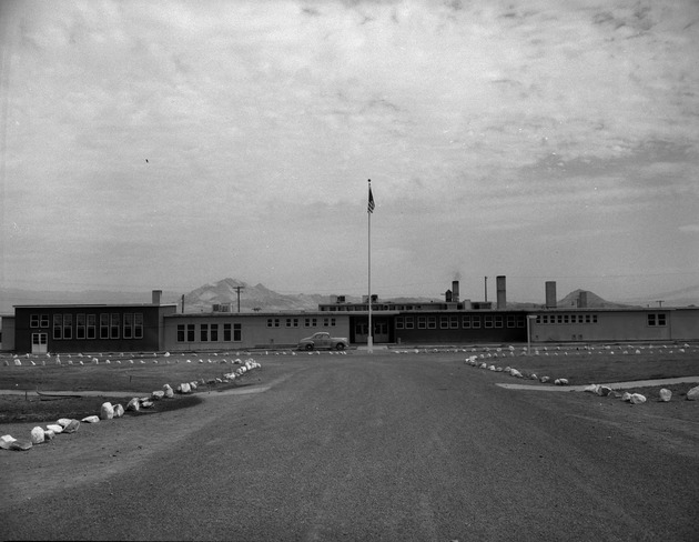 Photograph of a building and a car at Victory Village