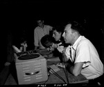 Photograph of Gail Wilson broadcasting a softball game