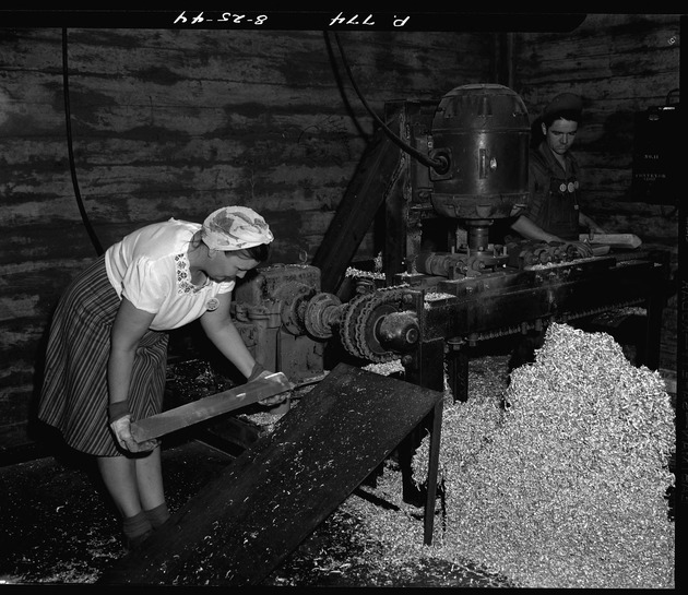 Photograph of a woman scalping ingots
