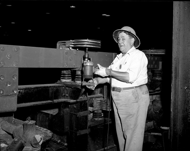 Photograph of Vic Neeley and his invention at Basic Magnesium, Inc.