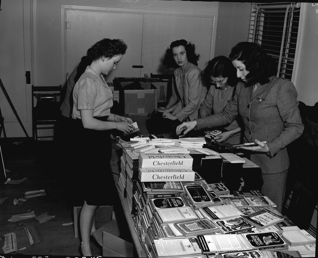 Photograph of Red Cross members assembling care packages for soldiers