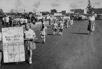 Photograph of children marching for Henderson District Public Library in the Industrial Days parade, Henderson, May 7, 1955