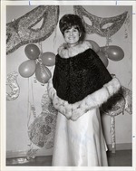 Photograph of Mrs. Harold Foster standing in front of Mardi Gras Ball decorations, Henderson, 1971