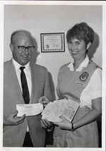 Photograph of Glen Taylor presenting a check to a Rose de Lima Hospital Auxiliary member, Henderson, 1969