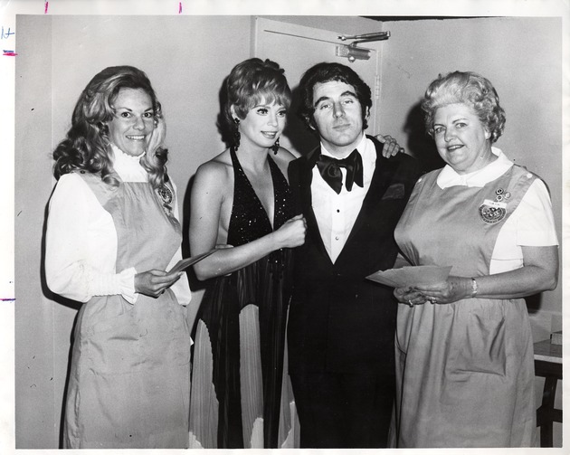 Photograph of three unidentified women and a man dressed for the Mardi Gras Ball, Henderson