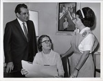 Photograph of a man and two women in an office