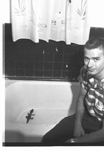 Photograph of Frank Wortman and an alligator in a bathtub, Henderson, 1963