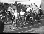 Photograph of George Crisler and children with bicycles, Henderson, 1953