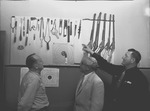 Photograph of Police Chief George Crisler and a weapons display, Henderson, circa 1954