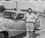 Photograph of Police Chief George Crisler and a patrol car, Henderson, 1953