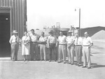 Photograph of a group of people standing outside a building in Henderson, circa 1955