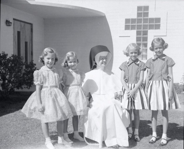 Photograph of an Adrian Dominican sister with girls at Rose de Lima Hospital, Henderson, September 1956