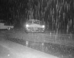 Photograph of a car driving in the rain, Henderson, July 24, 1955