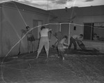Photograph of men trying to salvage their yard from the flood, Henderson, July 24, 1955