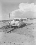 Photograph of a car stuck in the mud, Henderson, July 24, 1955