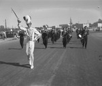 Photograph of the marching band lead by the drum major in Industrial Days parade, Henderson, May 7, 1955