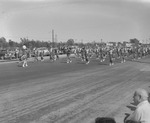 Photograph of a majorette leading a marching band in the Industrial Days parade, Henderson, May 7, 1955