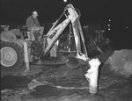 Photograph of people moving a fire hydrant, Henderson, March 1954