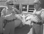 Photograph of policemen and a hawk, Henderson, September 1957