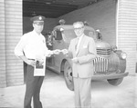 Photograph of Mayor Byrne buying a ticket to the Firemen's Ball, Henderson, September 1957