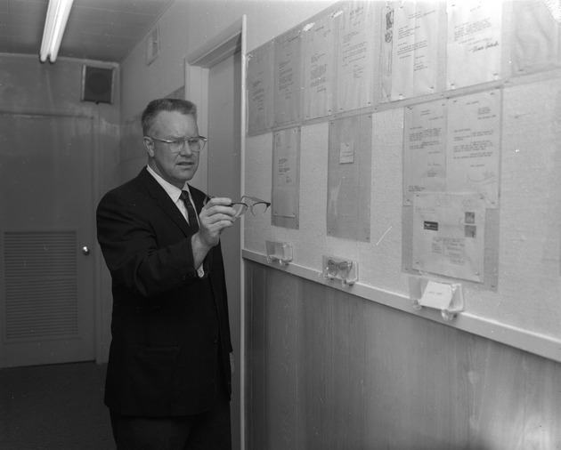 Photograph of a man in the Famous People's Eyeglasses Museum, Henderson, February 1963
