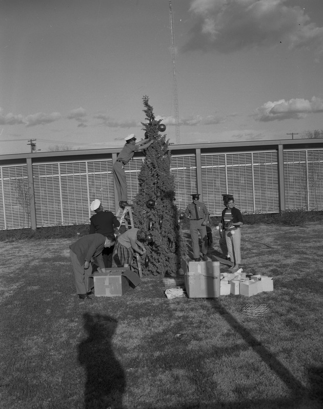 Photograph of people decorating outside City Hall, Henderson, December 1964